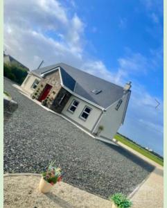 a house on the side of a road with aphalt at Glenmore in Doonbeg