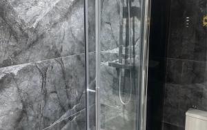 a shower with a glass door in a bathroom at Double Room Private Bathroom Parking South Croydon in Addington
