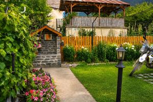 a garden with a motorcycle parked in the yard at House in Mestia in Mestia