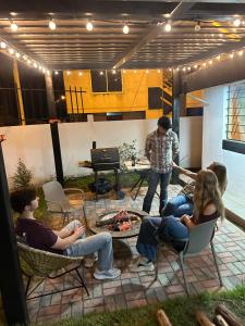 a group of people sitting in chairs watching a man play a video game at Flor de Naranjo in Tabacundo +4 photos