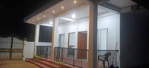 a lit up house with a porch at night at Sivas friendly guest house in Nilaveli