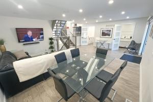a living room with a couch and a glass table at Luxe Home Near Limeridge - Sleeps 11 - Pool in Hamilton