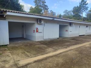 a garage with white doors and a fire hydrant at Motel Hotel Le Premier in Venâncio Aires