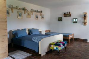 a bedroom with a bed and a bench in it at Matejev konak in Šušara