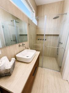 a bathroom with a sink and a shower at פלג טל -דפנה in Dafna