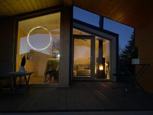 a large glass door of a room with a bedroom at 302 Charmantes naturnahes Tiny House- das Herman in Bleckede +11 photos