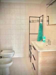 a bathroom with a white toilet and a sink at L'Oasi nel Centro in Ariano Irpino
