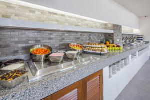 a buffet line with many different types of food at Wyndham Garden Playa del Carmen in Playa del Carmen