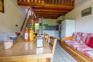 a kitchen with a table with a cell phone on it at Les Balcons de St So Appartement A in Saint-Sorlin-dʼArves