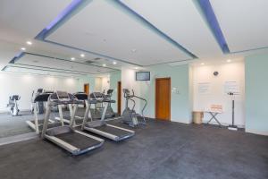 a gym with treadmills and ellipticals in a room at Wyndham Garden Playa del Carmen in Playa del Carmen