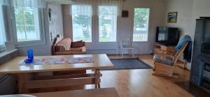 a living room with a table and a tv at Härköniemen mökki in Leppävirta