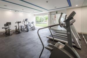 a gym with several treadmills and cardio machines at Wyndham Garden Playa del Carmen in Playa del Carmen +36 photos