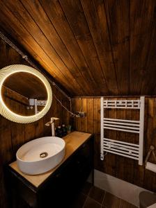 a bathroom with a sink and a mirror at Chalet Hatsvali - Ushba Viewpoint Rooms & Café in Mestia