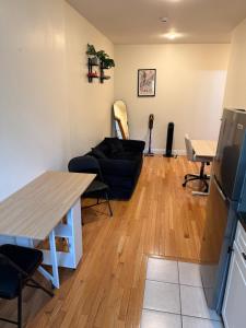 a living room with a couch and a table at Chic Times Square 1BR Entire Apt - Private Kitchen & Bath - Hosts 4 in New York