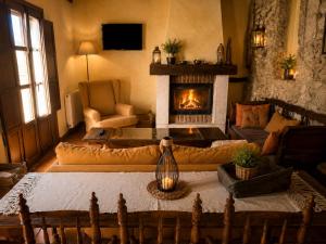 a living room with a fireplace and a couch at Casa Rural Canchalejo in Montánchez