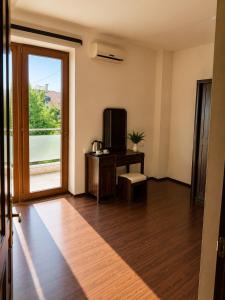 a room with a television and a table and a window at Dream House Hostel & Hotel in Yerevan
