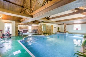 a large swimming pool in a house with wooden ceilings at 3 Bed in Stratton Strawless oc-w34832 in Stratton Strawless