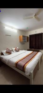 a bedroom with a large bed in a room at Vp residency in Bangalore