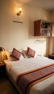 a bedroom with a large bed with pillows on it at Vp residency in Bangalore