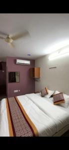 a bedroom with a large bed with two pillows at Vp residency in Bangalore