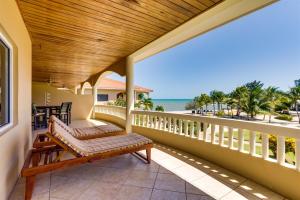 a porch with a bench and a view of the beach at Beachfront 2BR Villa with Pool & Spacious Layout in Placencia