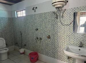 a bathroom with a sink and a toilet at Hotel Sunil Lodge in Gaurikund