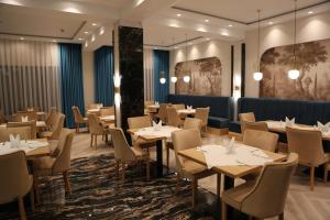 a restaurant with tables and chairs in a room at Pensiunea Palace in Baile Felix