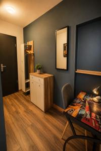 a room with a desk and a table and a chair at WELLNESS Hotel UHLENBERG in Bad Münstereifel