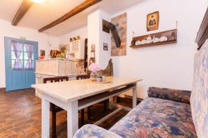 a kitchen and dining room with a table and a couch at Matejev konak in Šušara