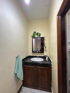 a bathroom with a sink and a mirror at rez-de-chaussée villa pour famille in Sidi Bouzid +5 photos