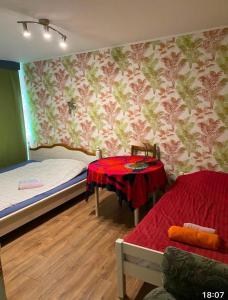 a room with two beds and a table in it at Jalaka 2- bedroom apartment 4 beds free parking in Tartu