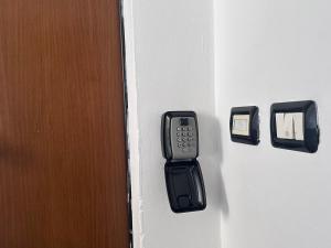 a door with a cell phone sticking out of it at L'Angolo di Luce in Falconara Marittima