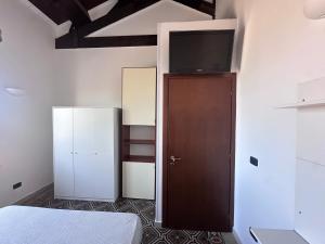 a bedroom with a bed and a flat screen tv at L'Angolo di Luce in Falconara Marittima