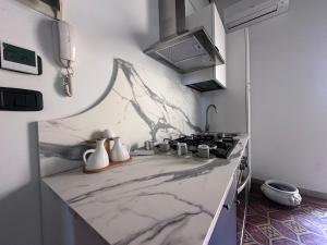 a kitchen with a marble counter top with a stove at L'Angolo di Luce in Falconara Marittima +7 photos