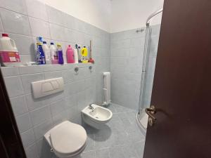 a white bathroom with a toilet and a shower at L'Angolo di Luce in Falconara Marittima