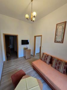a living room with a couch and a television at Hotel Corso T-X in Rokycany