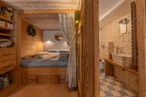 a bedroom with a bed and a sink and a tub at Les Évouettes Châtel village in Châtel