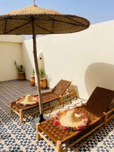 a room with two chairs and an umbrella at Riad Le Sultan Rouge And Spa in Marrakesh