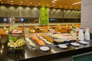 a buffet of food on a table in a restaurant at Transamerica Executive Sorocaba in Sorocaba