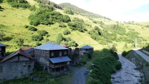an aerial view of a mountain with houses and a river at Raul Lushnu Darbaz in Mestia