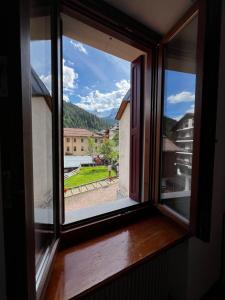 an open window with a view of a city at Albergo Brustolon in Dont +12 photos