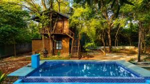 a tree house with a pool in front of it at wood cabin sigiriya in Sigiriya
