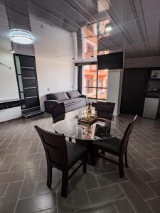 a living room with a table and chairs and a couch at Suites de Luxe en Hotel in Cuetzalán del Progreso