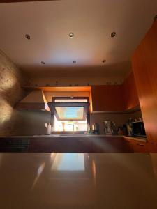 a kitchen with a window in the middle of it at Casa Vacanze PIAZZETTA in San Nico +9 photos