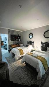 a large bedroom with two beds and a fireplace at Nestled Peace in Klerksdorp