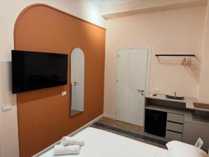 a bedroom with a flat screen tv on a wall at 2115 Boutique Hotel in Durrës