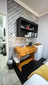 a bedroom with a wooden desk in a room at Nestled Peace in Klerksdorp +2 photos