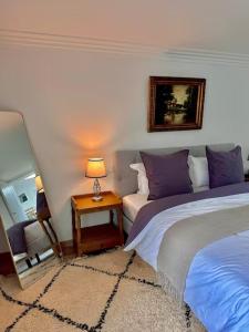 a bedroom with two beds and a table with a lamp at suite avec piscine et hammam en vendee in Breuil-Barret