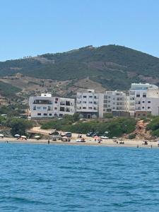 a group of buildings on a beach near the water at Appartement direct aan zee in Azla-Tetouan in Azla