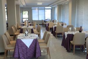 a dining room with tables and chairs with purple table cloth at Nile View Hotels in Bahir Dar +21 photos